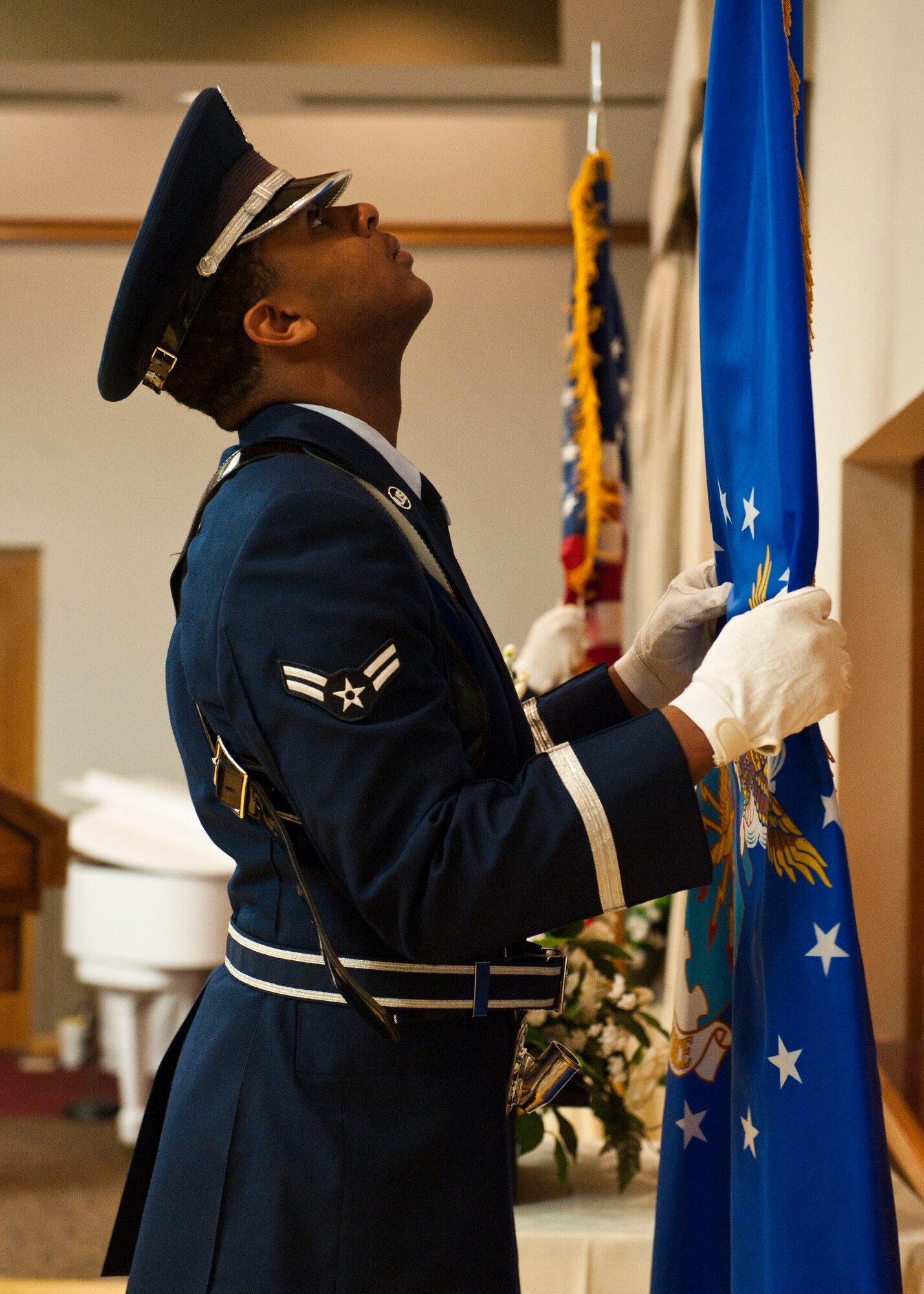 Nellis Air Force Base Honor Guard Airman 1st Class Therman Thomas posts the Air Force flag during the National Prayer Breakfast at the Club March 25, 2014, at Nellis AFB, Nev. The National Prayer Breakfast was inaugurated by President Dwight D. Eisenhower. The President, members of Congress and other government leaders gathered to reaffirm the nation’s spiritual heritage. (U.S. Air Force photo by Airman 1st Class Thomas Spangler)