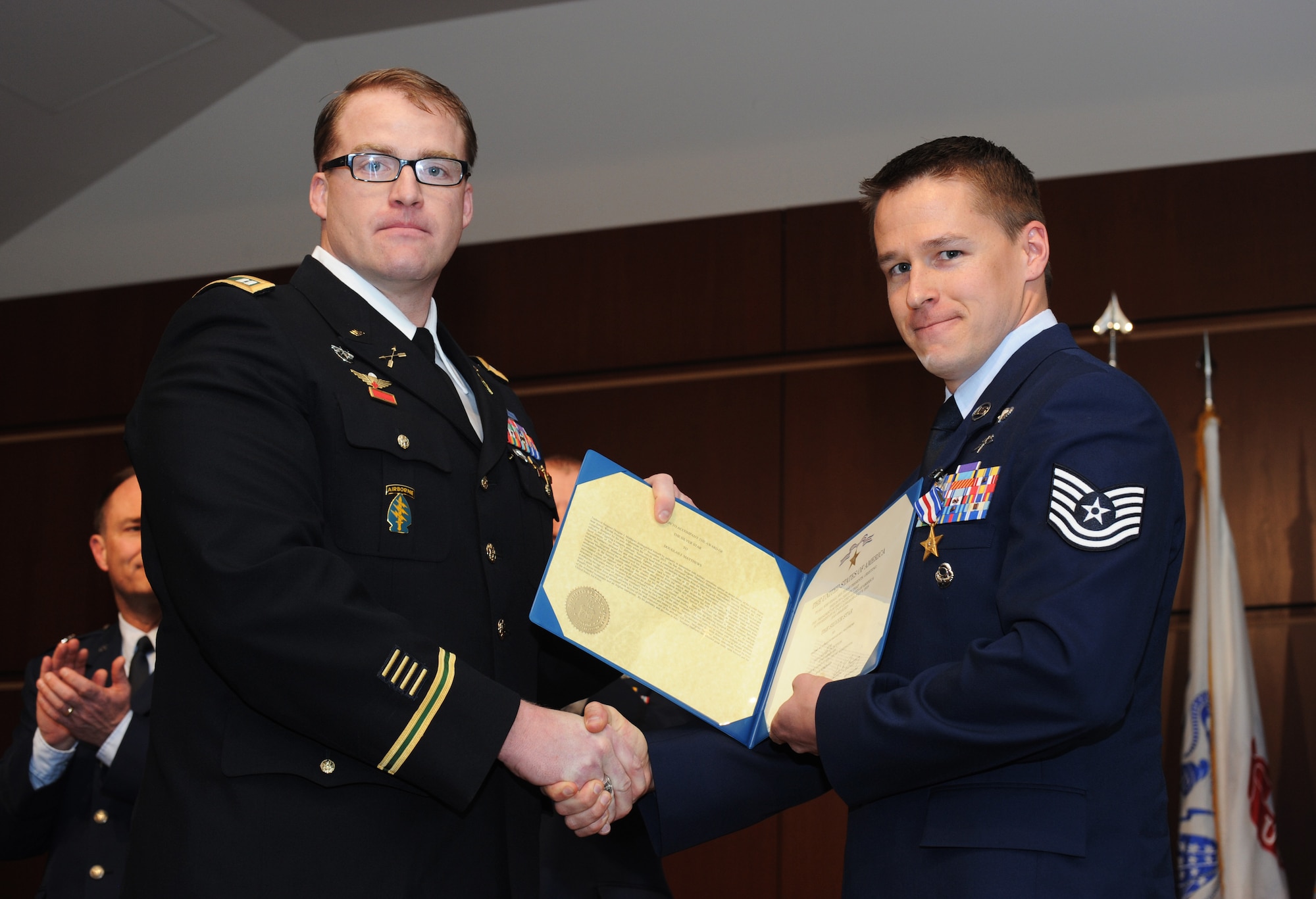 U.S. Army Capt. Seth Nieman (left) presents Tech. Sgt. Doug Matthews (right), a combat controller with the Oregon Air National Guard's 125th Special Tactics Squadron, with the rarely awarded Silver Star, March 24, during a ceremony at the 41st Infantry Division Armed Forces Reserve Center at Camp Withycombe, in Clackamas, Ore. Matthews' actions saved Nieman's life, along with other Special Forces teammates, during an ambush near Jalrez, Wardak Province in Afghanistan on Nov. 27, 2012. (U.S. Air National Guard photo by Tech. Sgt. John Hughel, 142nd Fighter Wing Public Affairs/Released) 