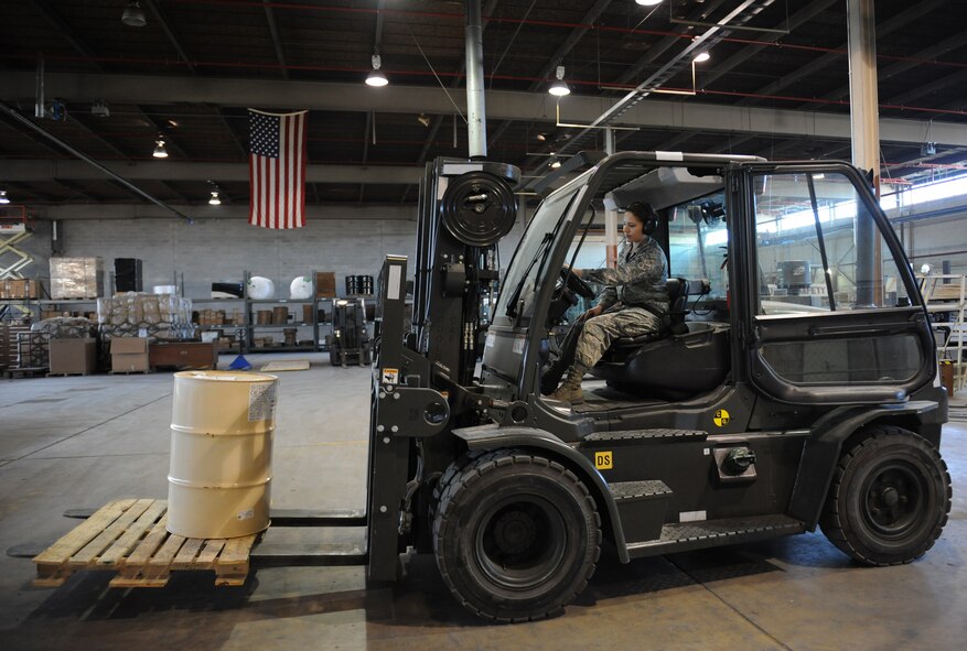 Airman 1st Class Janet Soto, 2nd Logistics Readiness Squadron shipping and distribution section, prepares to set a barrel on the ground while operating a 10K forklift on Barksdale Air Force Base, La., March 25, 2014. The shipping and distribution section can receive up to 10,000 pounds of shipments a day, which are then distributed to the base units. (U.S. Air Force photo/Senior Airman Benjamin Gonsier)