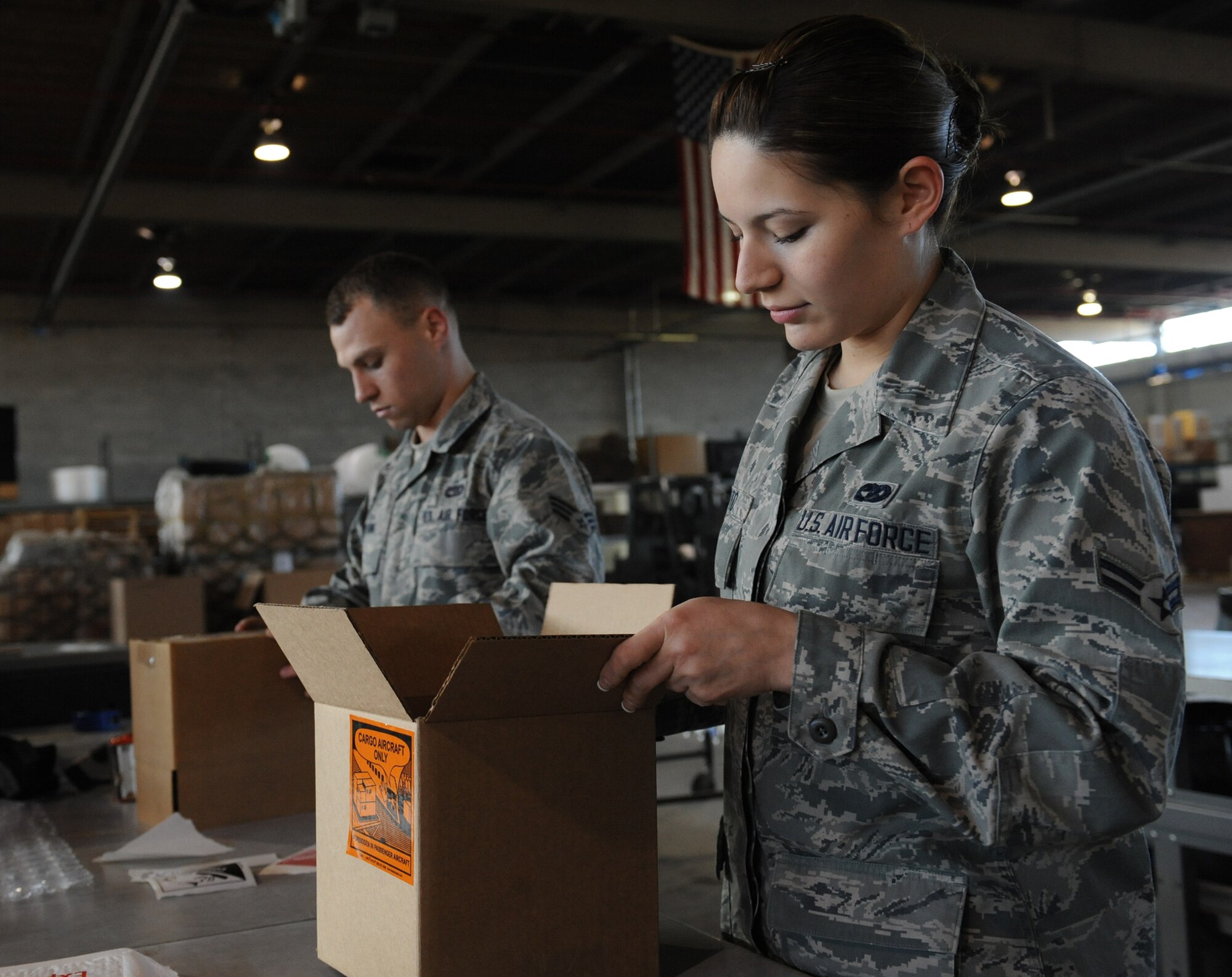 Airman 1st Class Janet Soto, right, and Senior Airman Justin Rushing, 2nd Logistics Readiness Squadron shipping and distribution section, prepare to pack cardboard boxes for shipment on Barksdale Air Force Base, La., March 25, 2014. The shipping and distribution section is responsible for receiving inbound shipments for the 2nd Bomb Wing and tenant units. (U.S. Air Force photo/Senior Airman Benjamin Gonsier)