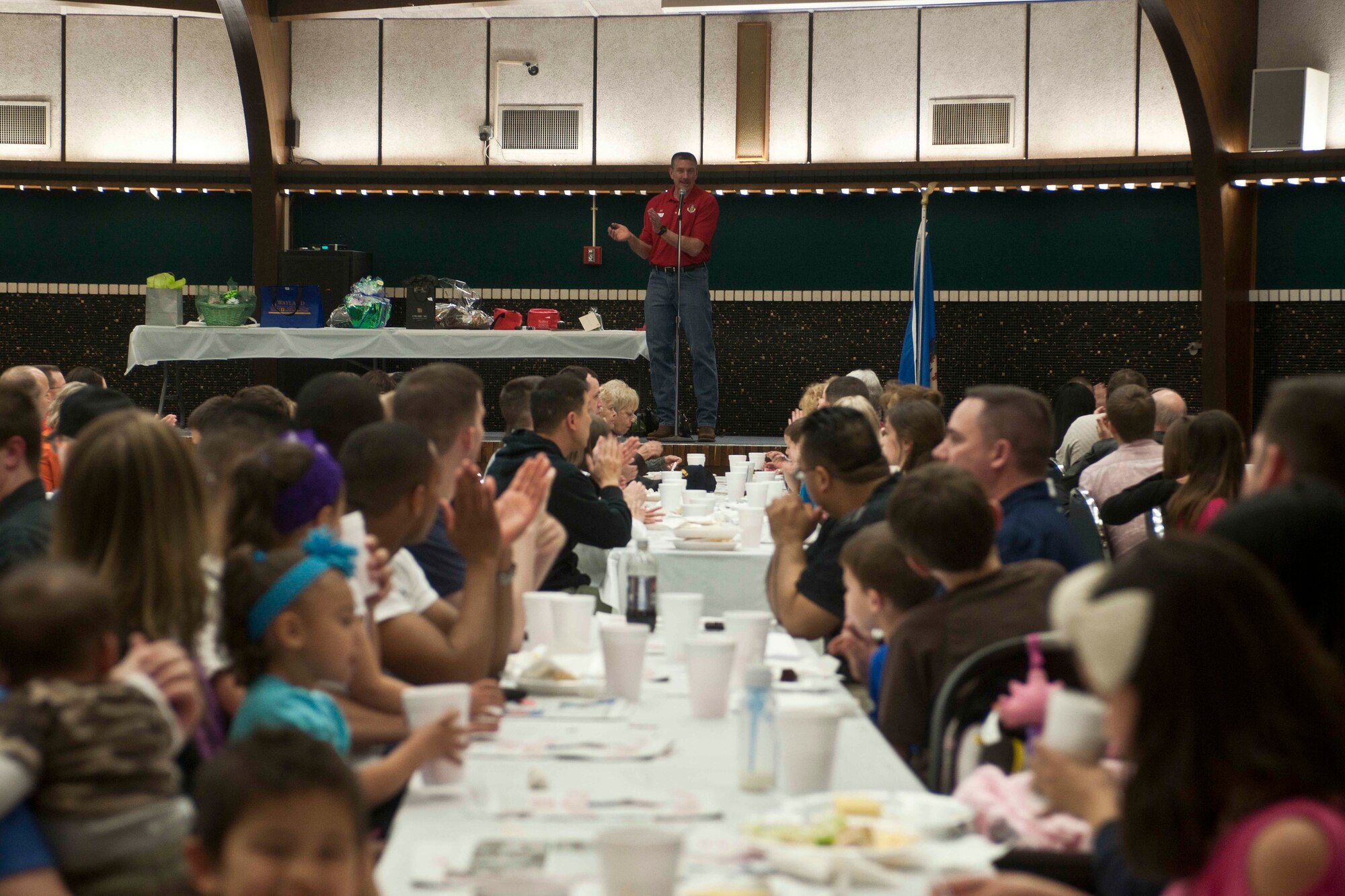 ALTUS, Okla. – U.S. Air Force Col. Bill Spangenthal, 97th Air Mobility Wing commander, welcomes members of Altus Air Force Base and the surrounding community during the Committee of 100 dinner held at the Altus High School Cafetorium, March 24, 2014. Altus AFB members, students, and those returning from the deployment are welcomed and introduced to local community members to help newcomers become familiar with Altus. (U.S. Air Force Photo by Senior Airman Jesse Lopez/Released)