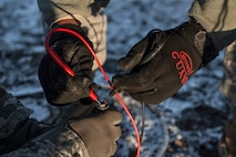 Airmen from the 5th Civil Engineer Squadron check the charge on a Precision Approach Path Indicator at Minot Air Force Base, N.D., March 19, 2014. The taxiway on which the PAPI is installed will act as an emergency runway during flight line construction to occur later this year. (U.S. Air Force photo/Senior Airman Stephanie Sauberan)