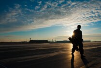 An Airman from the 5th Civil Engineer Squadron removes a Trimble Total Station from the flight line at Minot Air Force Base, N.D., March 19, 2014. The station was used to check the alignment of two Precision Approach Path Indicators and a snow fence which will act as temporary runway lighting and ending points during construction on the flight line later this year. (U.S. Air Force photo/Senior Airman Stephanie Sauberan)