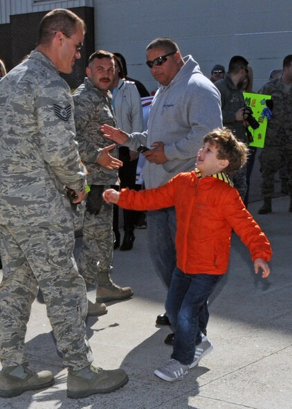 Familiy and friends rush to greet their loved ones upon their return. The Airmen are members of the 143d Airlift Wing returning from a deployment to Kuwait in support of Operation Enduring Freedom.. National Guard Photo by Master Sgt Janeen Miller (RELEASED)