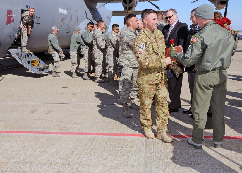 Members of the 143d Airlift Wing, returning from a deployment to Kuwait in support of Operation Enduring Freedom, are greeted by Wing and State Leadership. National Guard Photo by Master Sgt Janeen Miller (RELEASED)