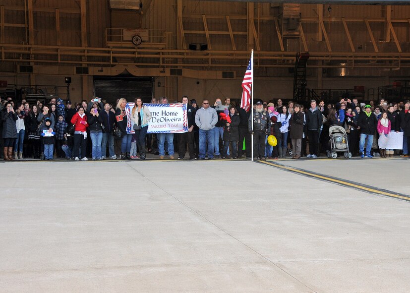 Excited family and friends await the arrival of the C-130J Super Hercules carrying members of the 143d Airlift Wing returning from a deployment to Kuwait in support of Operation Enduring Freedom. National Guard Photo by Master Sgt Janeen Miller (RELEASED)