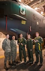 Staff Sgt. John M. Silva (second from the left), 5th Aircraft Maintenance Squadron dedicated crew chief, poses in front of his aircraft with a fellow crew chief and members of his air crew at Minot Air Force Base, N.D., Jan. 10, 2014. Through working cooperatively with the air crew, Silva strives to strengthen the bond between maintenance and air crews. (U.S. Air Force photo/Airman 1st Class Apryl Hall)