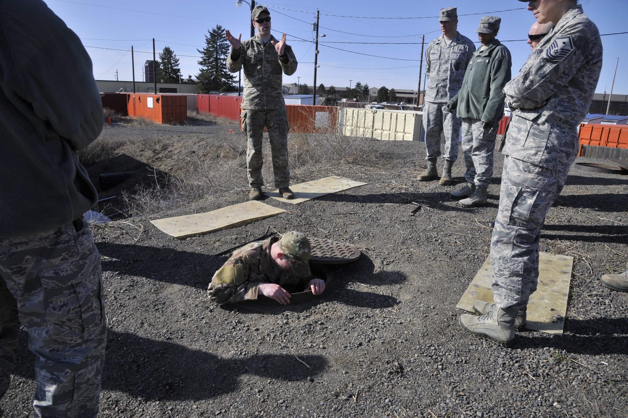 Squadron leadership from the 92nd Mission Support Group watch as an Airman demonstrates different evasion tactics during a tour of the Urban Evasion Lab at Fairchild Air Force Base, Wash., March 21, 2014. The MSG members toured Survival, Evasion, Resistance and Escape facilities during an immersion to better understand the partnership between tenant units. (U.S. Air Force photo by Senior Airman Mary O'Dell/Released)