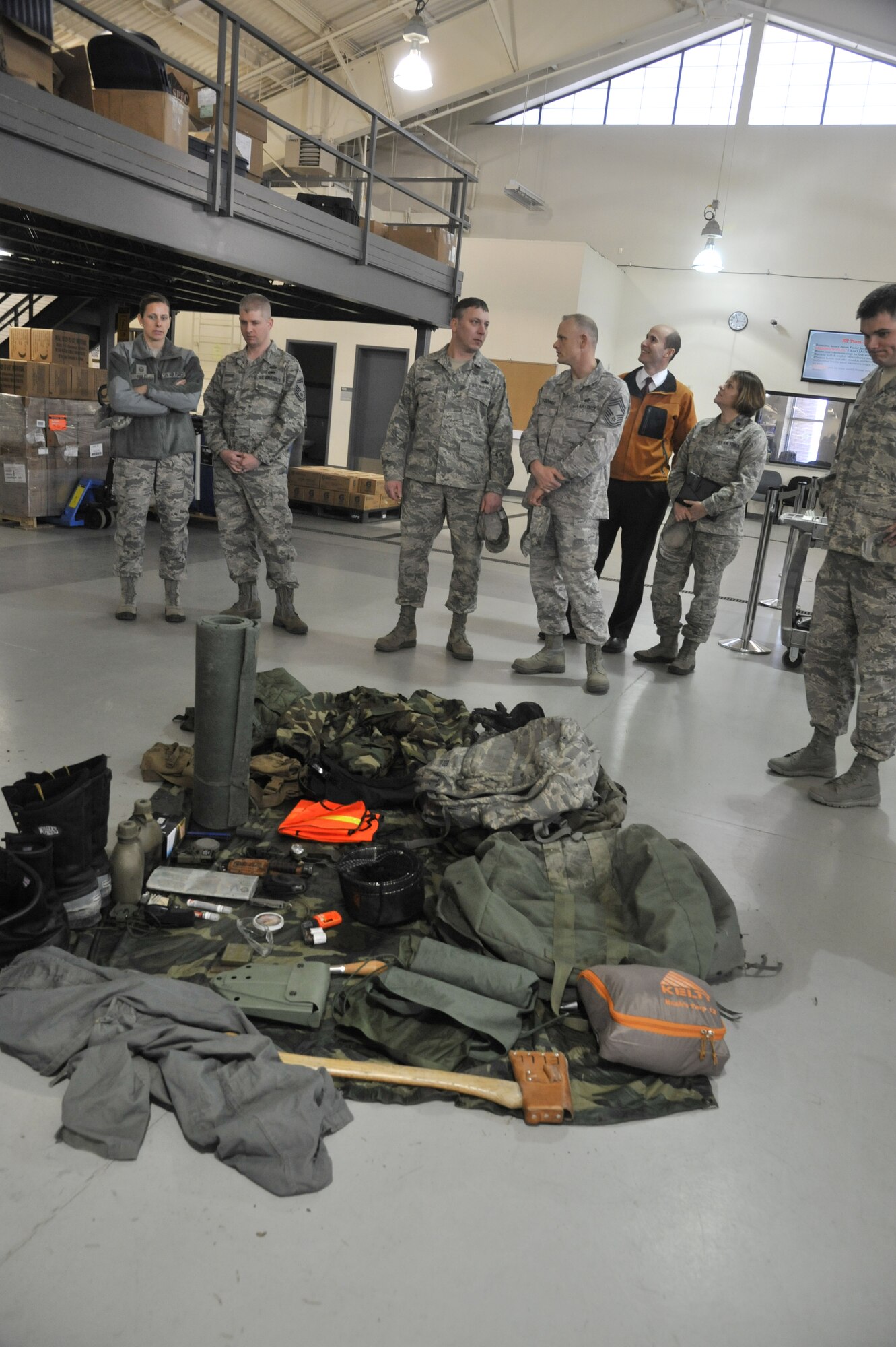 Members of the 92nd Mission Support Group look through gear taken to the field by Survival, Evasion, Resistance and Escape students during a tour at Fairchild Air Force Base, Wash., March 20, 2014. MSG squadron commanders, first sergeants and superintendents toured the SERE facilities during an immersion to better understand the working relationship between the 92nd Air Refueling Wing and the 336th Training Group. (U.S. Air Force photo by Senior Airman Mary O'Dell/Released)