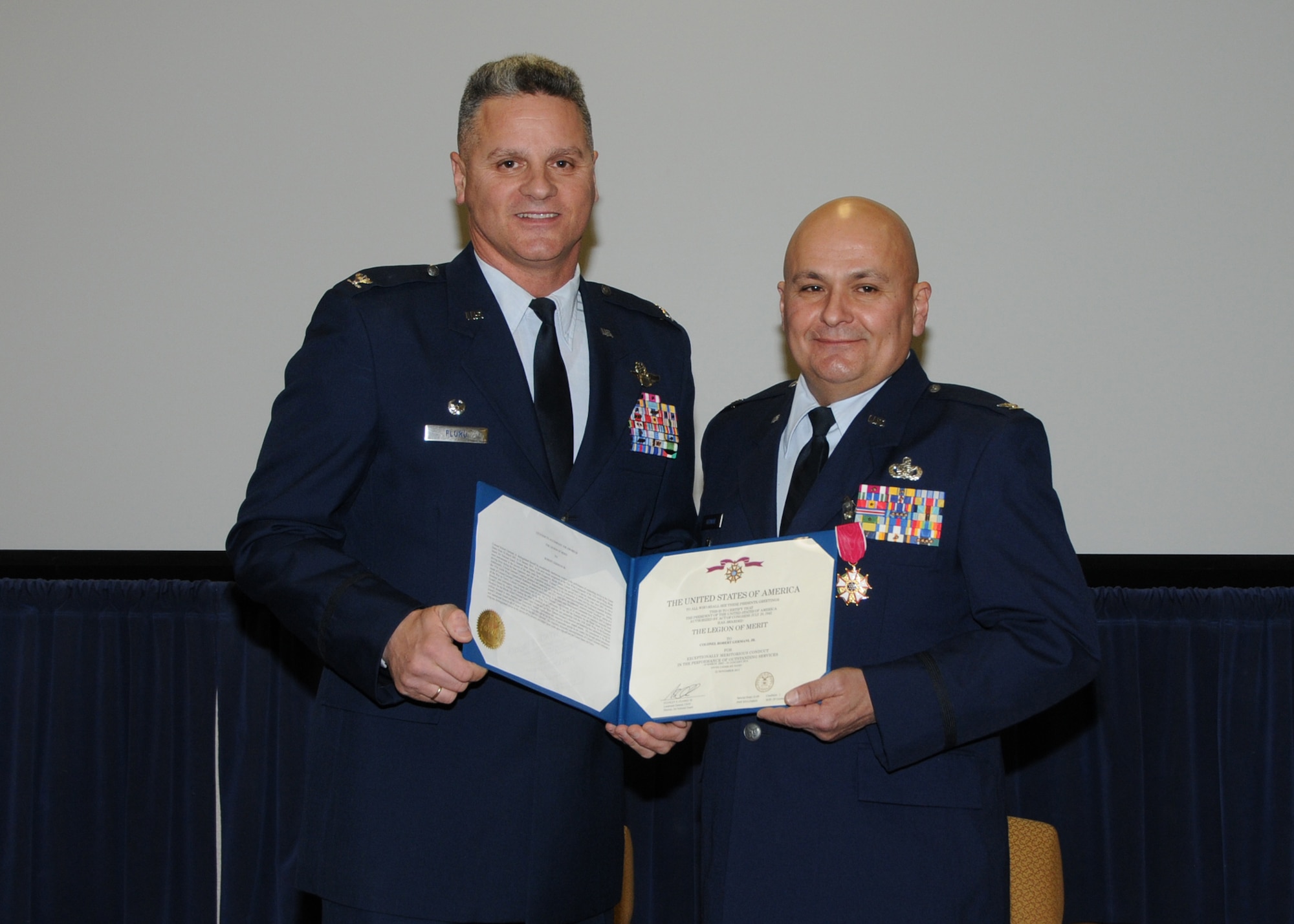 Colonel Arthur Floru (right), 143d Airlift Wing Commander, presents Colonel Robert Germani Jr. (left), outgoing 143d Airlift Wing Vice Commander with the Legion of Merit upon his retirement after 34 years of dedicated service to the Rhode Island National Guard. National Guard Photo by Technical Sgt Jason Long (RELEASED)