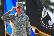Senior Airman Amber Coley, 4th Medical Operations Squadron physical therapist, salutes during the 4th Fighter Wing Prisoner of War/Missing in Action (POW/MIA) ceremony, Sept. 20, 2013, at Seymour Johnson Air Force Base, N.C.  Coley performed in the colors flight for three years during her tour with the U.S Air Force Honor Guard.  (U.S. Air Force photo/Senior Airman Aubrey White)