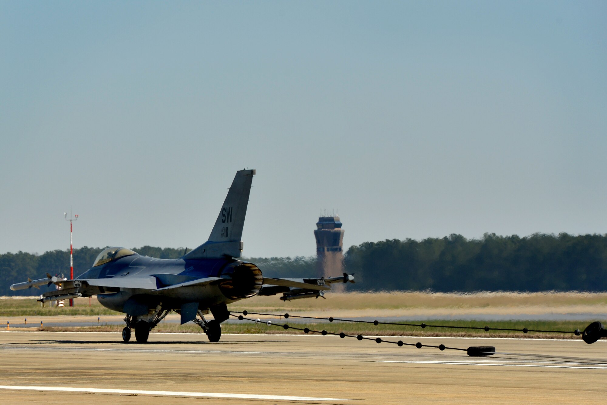 A U.S. Air Force F-16CJ Fighting Falcon piloted by Maj. Justin Lewis, 55th Fighter Squadron, is brought to a stop by an Aircraft Arresting System cable during a function test, March 21, 2014, Shaw Air Force Base, S.C. Shaw operates with two types of arresting systems, the BAK-12 and the E-5 totaling eight systems throughout the flightline. These systems can be used anytime aircrew deems it unsafe to stop on their own. (U.S. Air Force photo by Staff Sgt. Kenny Holston/Released)