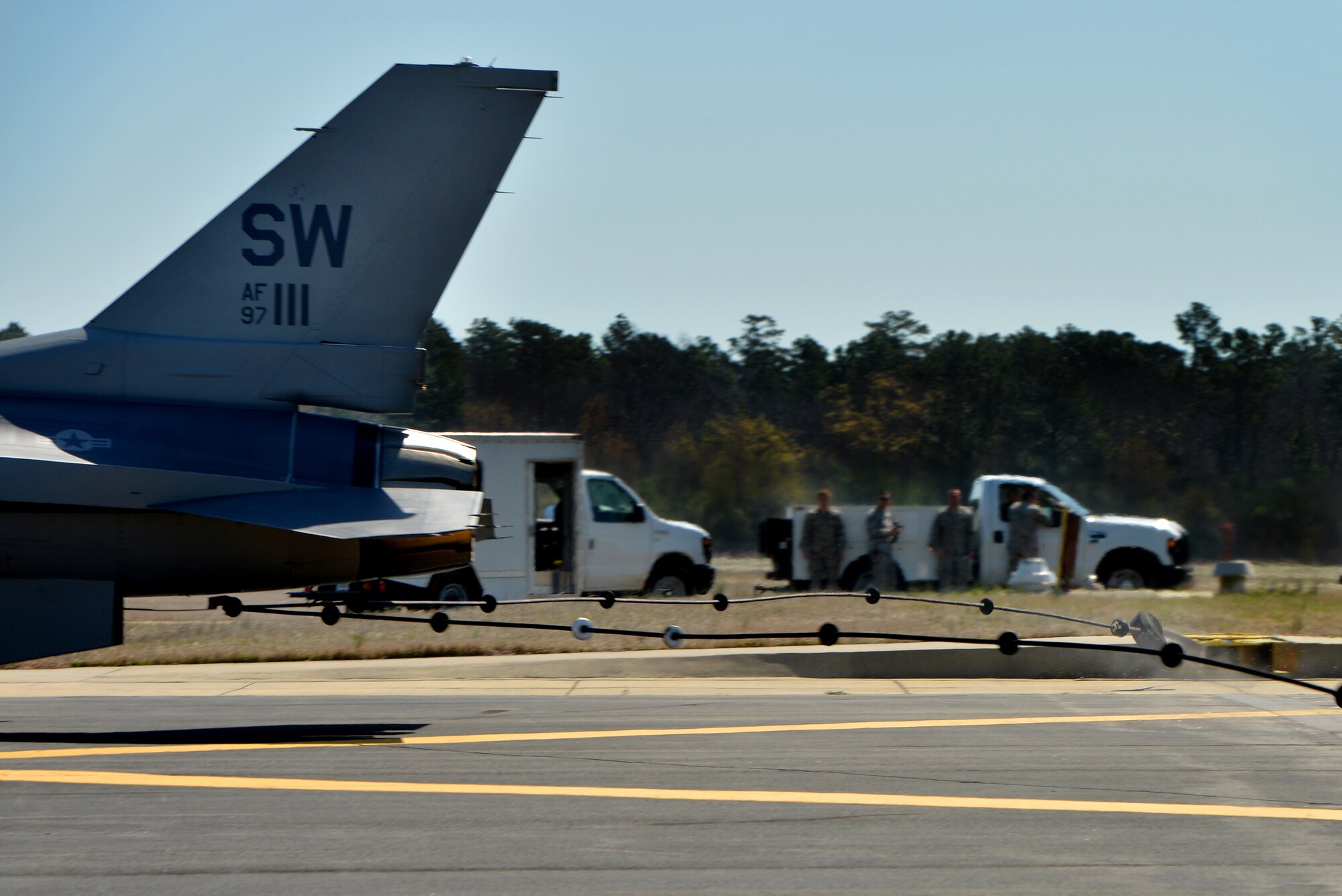 A U.S. Air Force F-16CJ Fighting Falcon piloted by Maj. Justin Lewis, 55th Fighter Squadron, catches onto an Aircraft Arresting System cable during a function test, March 21, 2014, Shaw Air Force Base, S.C. Shaw operates with two types of arresting systems, the BAK-12 and the E-5 totaling eight systems throughout the flightline. These systems can be used anytime aircrew deems it unsafe to stop on their own. (U.S. Air Force photo by Staff Sgt. Kenny Holston/Released) 