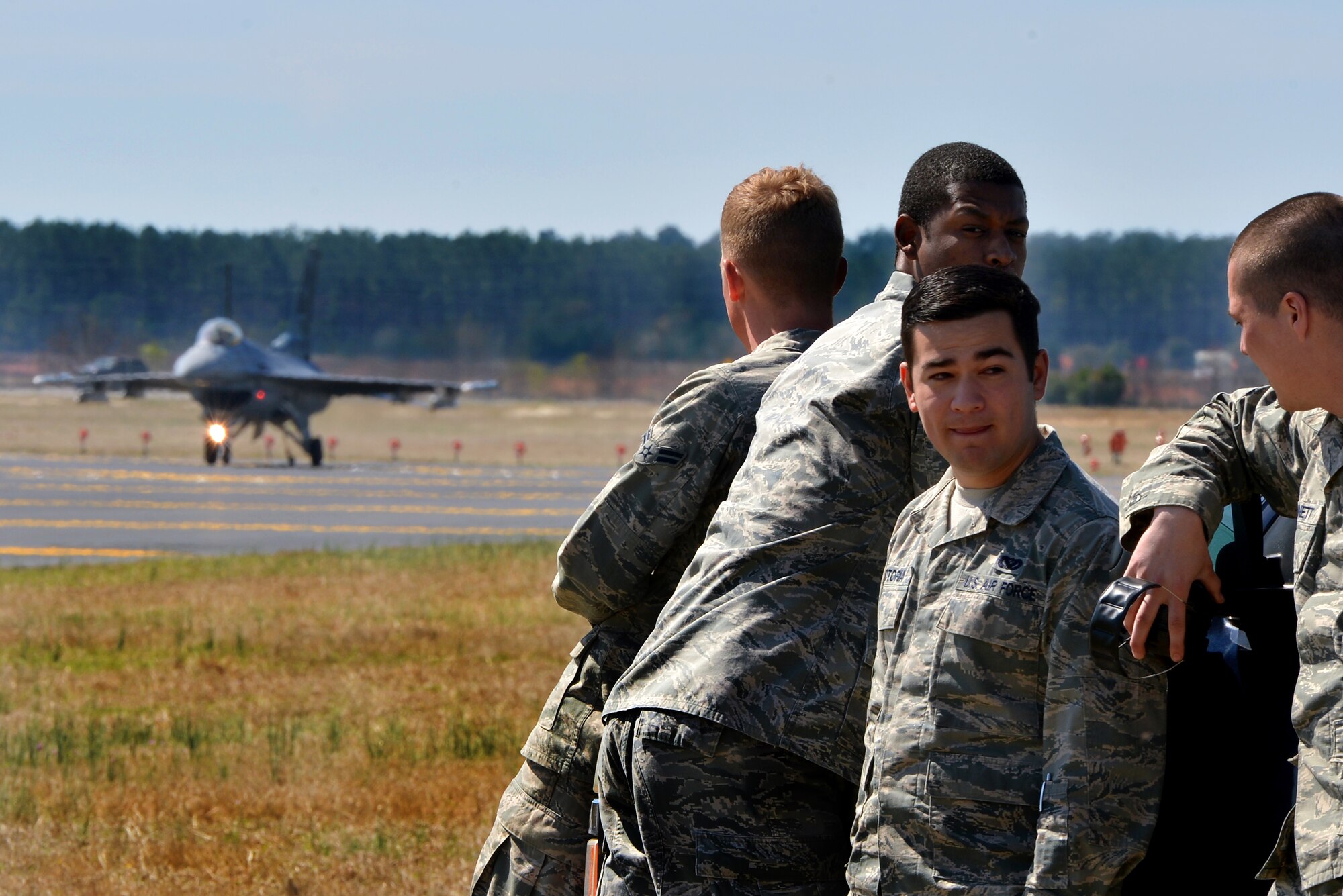 Airmen Assigned to the 20th Civil Engineer Squadron get in place to watch an F-16CJ Fighting Falcon test an Aircraft Arresting System, March 21, 2014, Shaw Air Force Base, S.C. The AAS is required to be tested annually. 20th CES Airmen are responsible for setting up the system and logging any deficiencies during the test. (U.S. Air Force photo by Staff Sgt. Kenny Holston/Released)