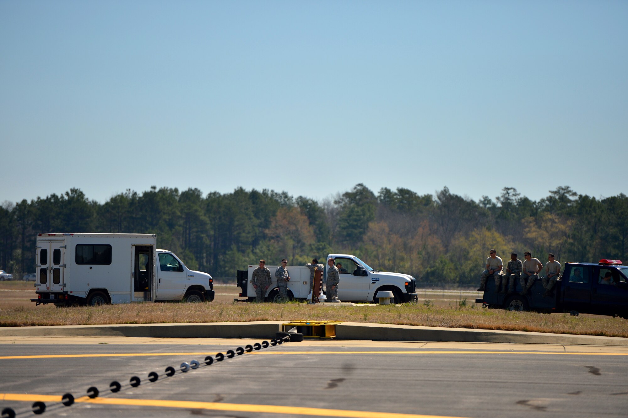 An Aircraft Arresting System cable is stretched across the Shaw Air Force Base, S.C. runway in preparation to test the AAS for accuracy and proper function, March 21, 2014, Shaw. During a system check, Airmen test an array of things including the proper operation of the hydraulic brake system which is what stops the aircraft. (U.S. Air Force photo by Staff Sgt. Kenny Holston/Released)
