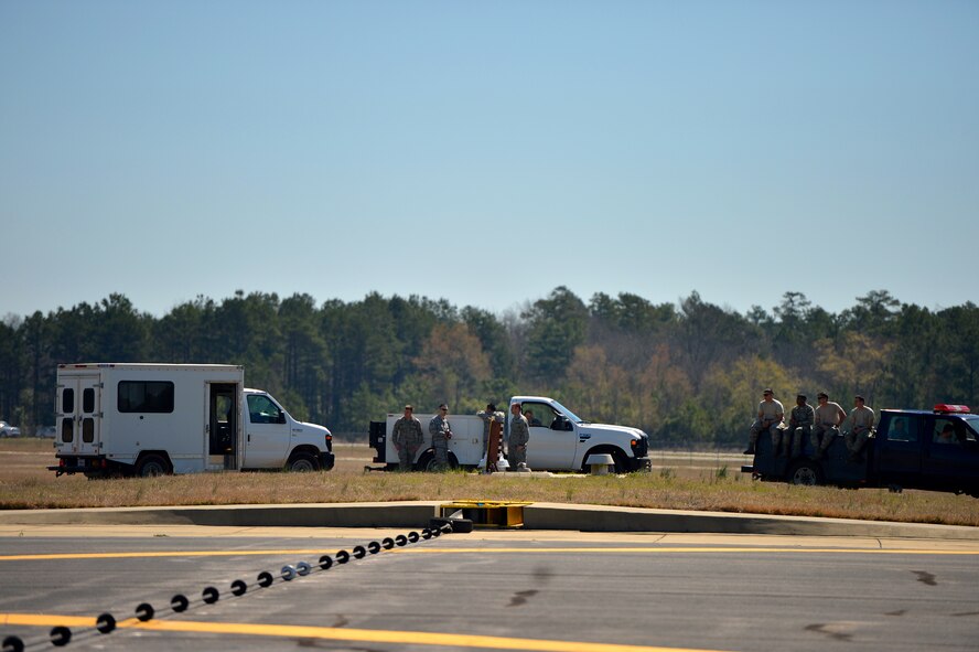 An Aircraft Arresting System cable is stretched across the Shaw Air Force Base, S.C. runway in preparation to test the AAS for accuracy and proper function, March 21, 2014, Shaw. During a system check, Airmen test an array of things including the proper operation of the hydraulic brake system which is what stops the aircraft. (U.S. Air Force photo by Staff Sgt. Kenny Holston/Released)