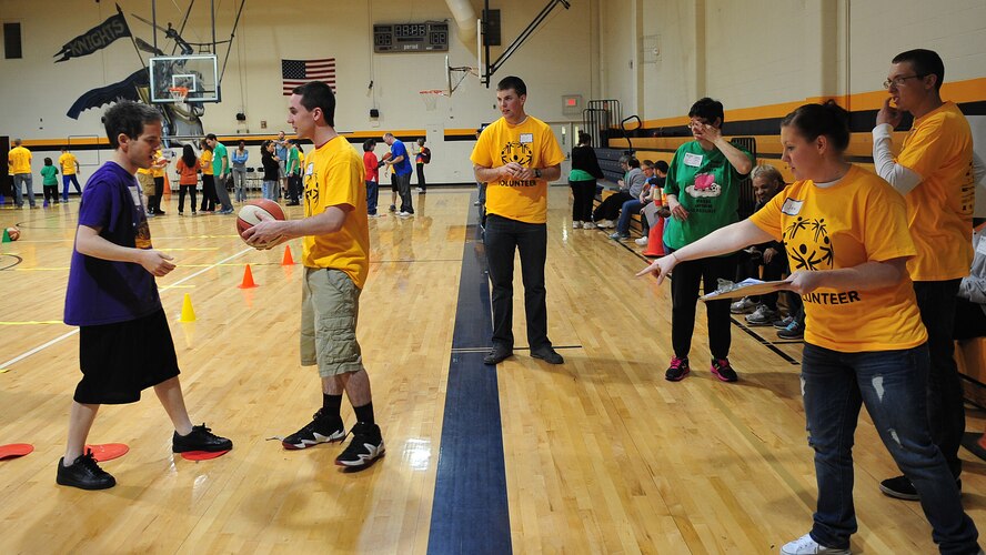 U.S. Air Force 2nd Lt. Jessica Dambrosio, right, 4th Contracting Squadron contracting specialist, assists an athlete at the dribbling station of the Special Olympics, March 15, 2014, in Smithfield, N.C. Dambrosio was an athlete escort for the event who said it was rewarding to put a smile on an athlete’s face. (U.S. Air Force photo/Airman 1st Class Shawna L. Keyes)