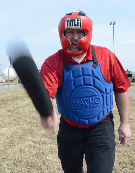 Charles Gray, 436th Medical Dental Squadron Honorary Commander, takes a swing with a padded Armament Systems and Procedures (ASP) baton during a training session with the 436th Security Forces Squadron on March 21, 2014, at Dover Air Force Base, Del. Gray, along with other Honorary Commanders, were trained how to effectively use the ASP baton and then allowed to put the training into action by sparring with an opponent. (U.S. Air Force photo/Greg L. Davis)