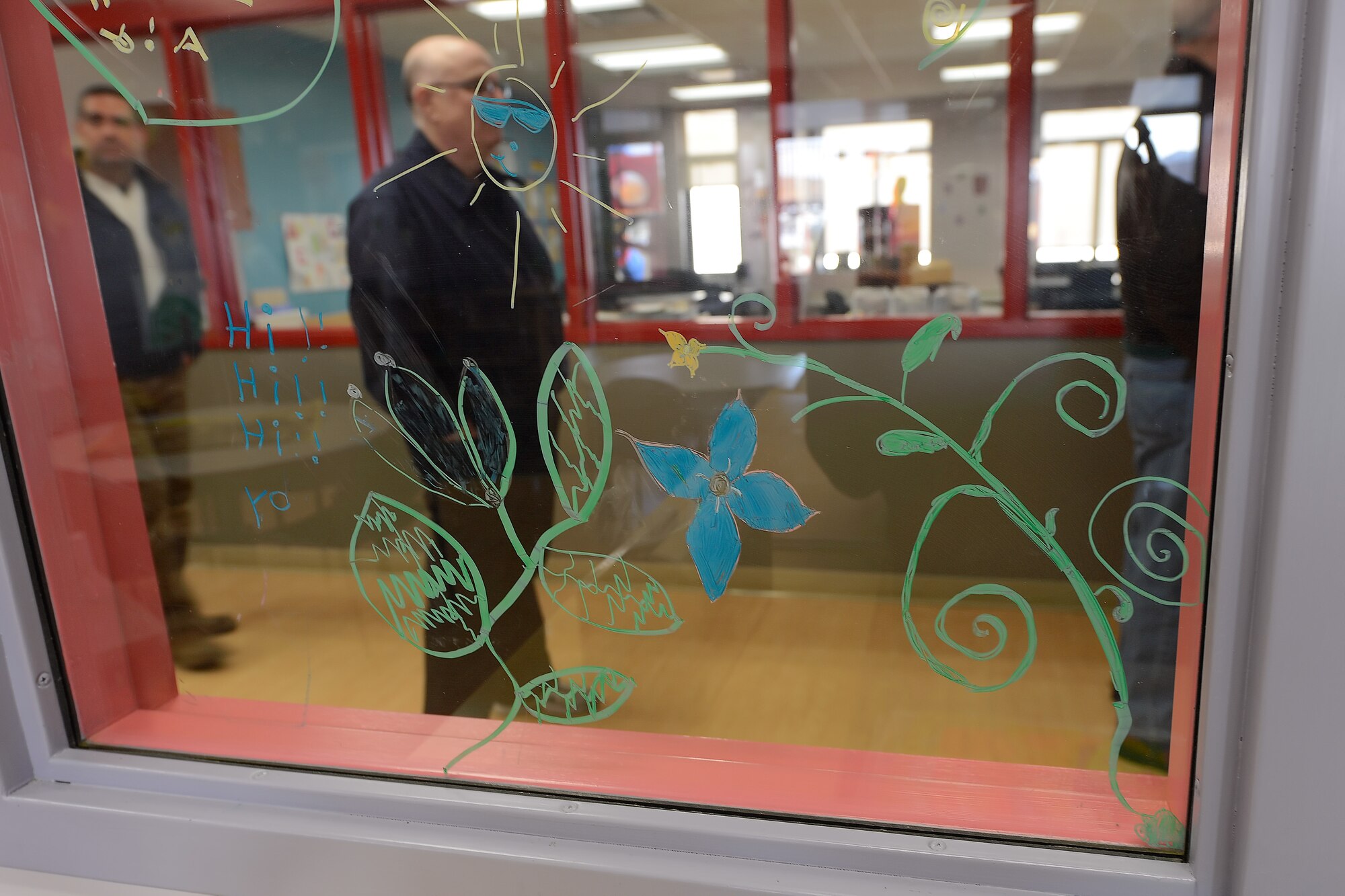 Colorful grease-pencil artwork drawn on classroom windows at the Dover Youth Activities Center greets Dover's Honorary Commanders as they tour the facility on March 21, 2014, at Dover Air Force Base, Del. Honorary Commanders got the opportunity to see the facility which is a 436th Mission Support Group function during their tour. (U.S. Air Force photo/Greg L. Davis)