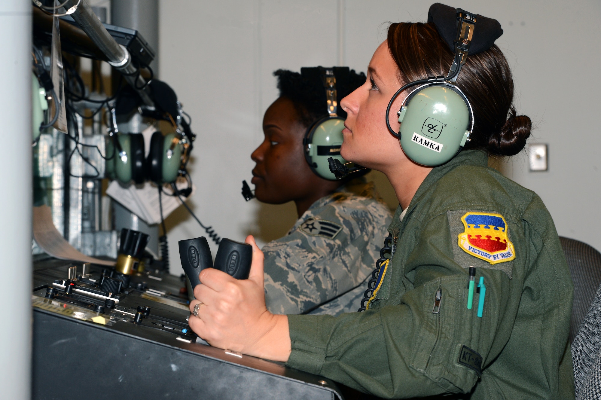 U.S. Air Force Airman 1st Class Christina Kamka, 20th Aerospace Medicine Squadron Aerospace and Operational Physiology technician (right), operates the hypobaric chamber as Senior Airman Paville Aldridge, 20th AMDS Aerospace and Operational Physiology technician (left), informs trainees on what to expect at that simulated altitude, Shaw Air Force Base, S.C., March 13, 2014. Trainees are taken to a simulated altitude of 25,000 feet to determine their hypoxia symptoms. (U.S. Air Force photo by Airman 1st Class Jonathan Bass/Released)