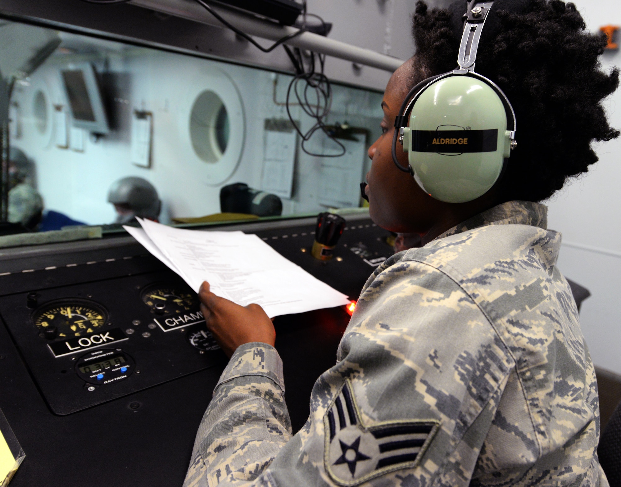 U.S. Air Force Senior Airman Paville Aldridge, 20th Aerospace Medicine Squadron Aerospace and Operational Physiology technician, instructs students on the symptoms of hypoxia, Shaw Air Force Base, S.C., March 13, 2014. Hypoxia is caused by the lack of oxygen in the blood. (U.S. Air Force photo by Airman 1st Class Jonathan Bass/Released)