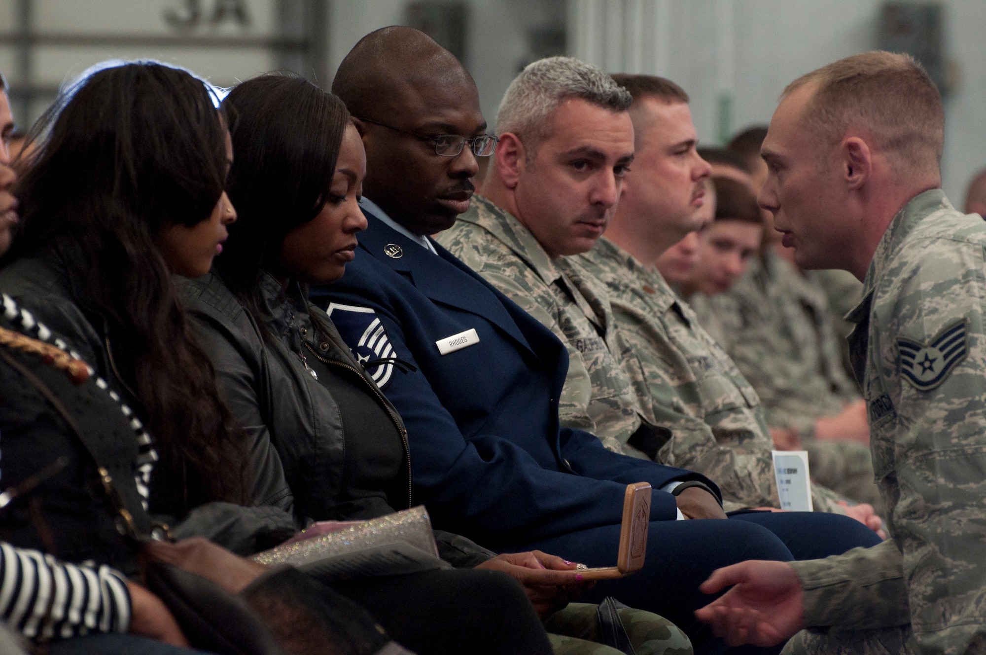 Staff Sgt. Brian Nafziger, 90th SFG TRF team lead assaulter, sniper and breacher, presents Anita Reed, mother of Airman 1st Class Dominique Hudson, with a memorial plaque – which includes Hudson’s name, rank, Talon Number and the SFG patch – March 21 after officially retiring his Talon Number during a memorial service in the Peacekeeper High Bay, Bldg. 1501. A Talon Number is assigned to each individual who is part of the Tactical Response Force. (U.S. Air Force photo by Airman 1st Class Brandon Valle)