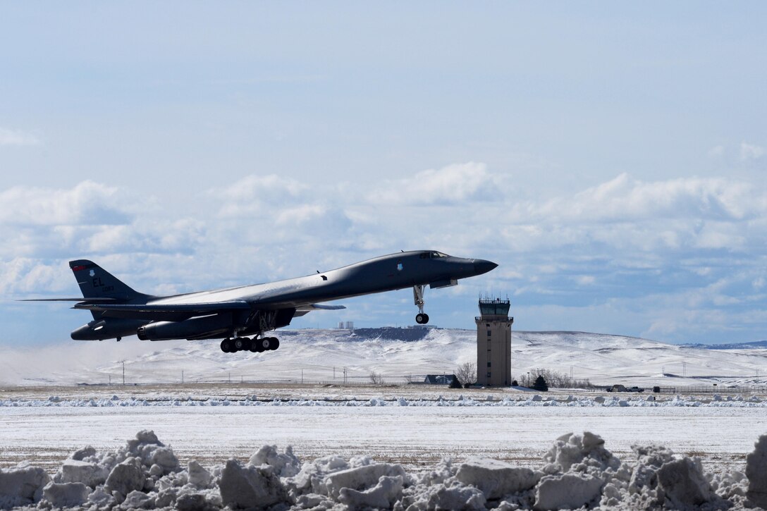 Amidst a winter landscape, a B-1 bomber rumbles skyward during operations at Ellsworth, S.D., March 18, 2014. Base aircrews conducted missions to and from a forward operating location in Southwest Asia, swapping aircraft due for scheduled maintenance. (U.S. Air Force photo by Airman 1st Class Rebecca Imwalle /Released)