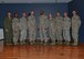 Col. David E. Graff, 325th Fighter Wing commander (far left) and Chief Master Sgt. Raymond F. DeVite, 325th FW Command Chief Master Sergeant (far right), pose for a group photo with Tyndall’s newest senior master sergeant selectees March 21 at the Horizons ballroom.  (U.S. Air Force photo by Staff Sgt. Javier Cruz)