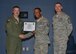 Col. David E. Graff, 325th Fighter Wing commander (left) and Chief Master Sgt. Raymond F. DeVite, 325th FW Command Chief Master Sergeant (far right), present Master Sgt.Deric M. Walker, 325th Mission Support Group (middle) with his senior master sergeant promotion line number certificate March 21 at the Horizons ballroom. Team Tyndall recognized nine senior master sergeants promotes.  (U.S. Air Force photo by Staff Sgt. Javier Cruz)