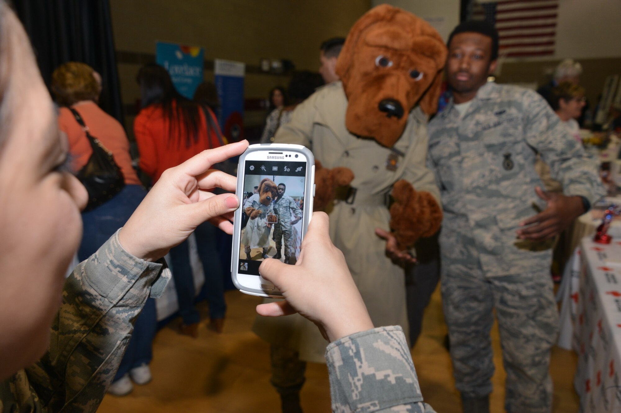An Airman takes a moment to pose with McGruff the Crime Dog at the Wellness Expo March 21. More than 600 people attended the fair, which was hosted by Kirtland's helping agencies to promote health. (Photo by Todd Berenger)