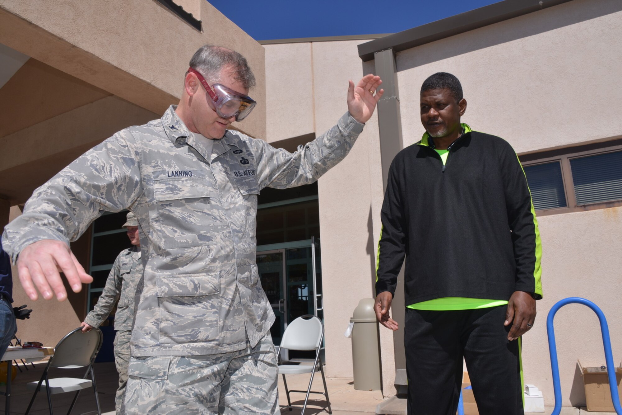 Col. Jeffrey Lanning, 377th Mission Support Group commander, walks with "beer googles" that simulate drunkenness at the Wellness Expo March 21. More than 600 people attended the fair, which was hosted by Kirtland's helping agencies to promote health. (Photo by Todd Berenger)
