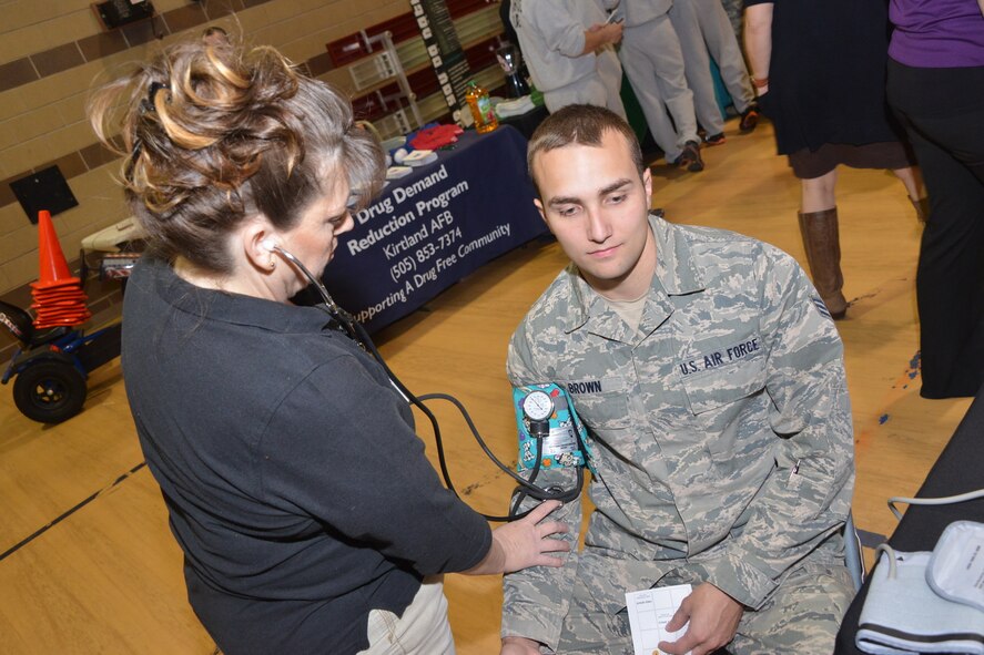 Senior Airman Dale Brown, 377th Dental Squadron, gets his blood pressure taken at last year's Wellness Expo. Attending this year's expo, which takes place July 28, will count towards fulfilling the Air Force annual requirement of participating in two wingman activities. (Photo by Todd Berenger)