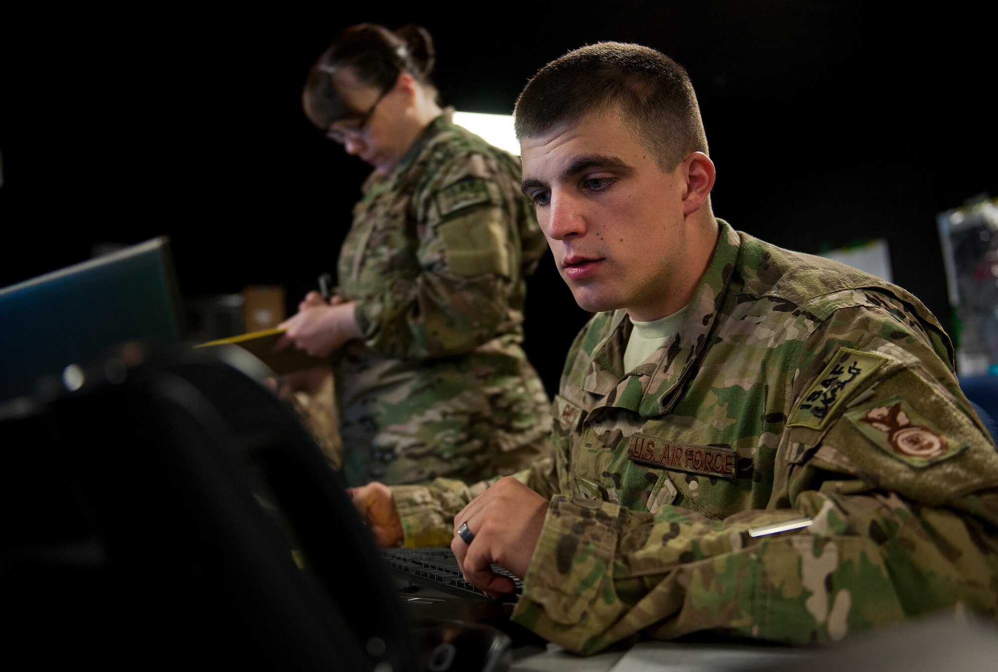 Staff Sgt. Joseph Riello, of the 902nd Security Forces Squadron from Randolph AFB, Texas, serves as the watch keeper, during a Joint Defense Operations Center exercise at Eglin AFB, Fla., March 21. The exercise simulated real-world force protection conditions at Kandahar Air Field, Afghanistan, to help deployers have specific location training before arriving to their new assignment. The training was facilitated by the 96th Ground Combat Training Squadron. (U.S. Air Force photo/Samuel King Jr.)