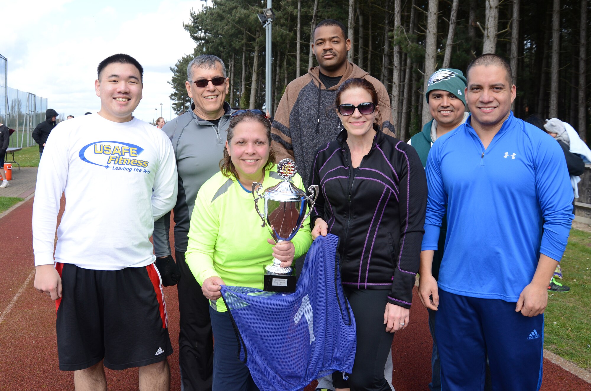 The Blue Team members display the trophy they won for the fastest time while competing in the last group event during a weight-loss competition March 22, 2014, on RAF Mildenhall, England. The competition began Feb. 3, and is scheduled to end March 28. By winning this competition, the Blue Team has earned more points. The team with the most points wins. (U.S. Air Force photo by Airman 1st Class Kelsey Waters/Released)