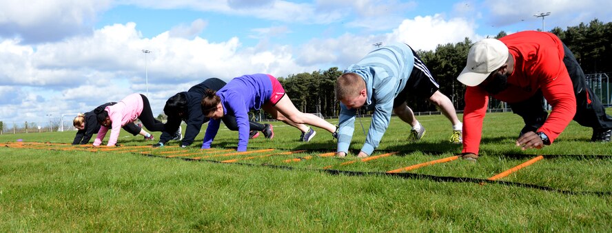 Members of the Purple Team perform an exercise during a weight-loss competition March 22, 2014, on RAF Mildenhall, England. The competition began Feb. 3, and is scheduled to end March 28. The competition will recognize an individual winner for the most weight lost and a team winner for the most points accumulated. (U.S. Air Force photo by Airman 1st Class Kelsey Waters/Released)