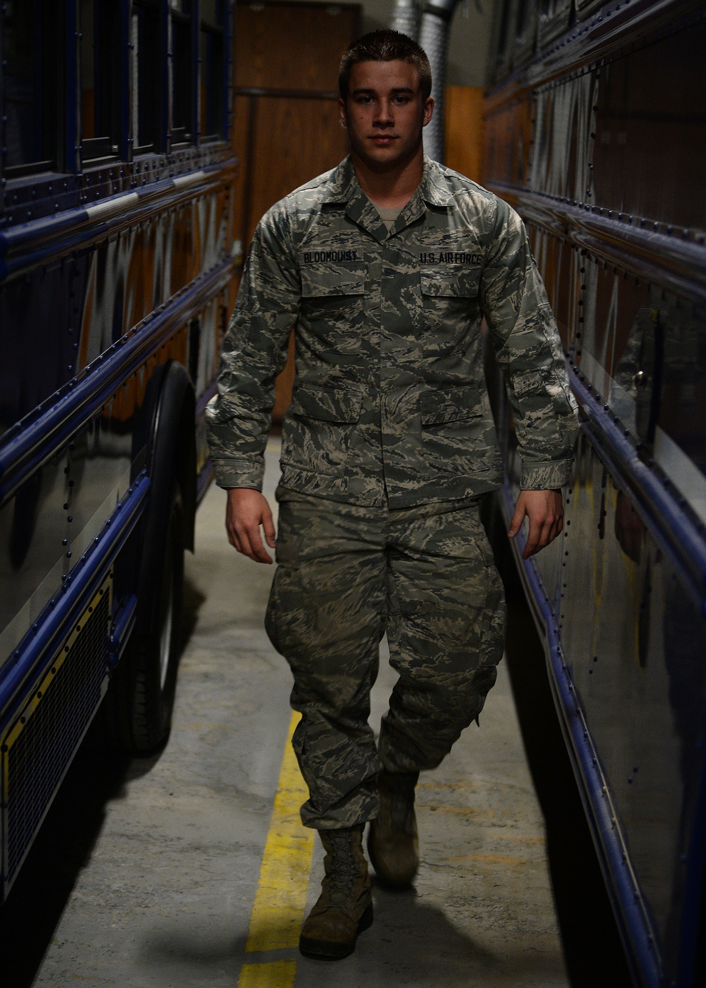 Senior Airman Gregory Bloomquist, 354th Logistic Readiness Squadron vehicle operator, walks between two buses at the vehicle operations flight’s indoor parking garage March 18, 2014 Eielson Air Force Base, Alaska. The vehicle operations flight controls more than 80 vehicles to help Eielson support its day-to-day missions and keep the aircraft in the sky during RED FLAG-Alaska. (U.S. Air Force photo by Staff Sgt. Shawn Nickel/Released)