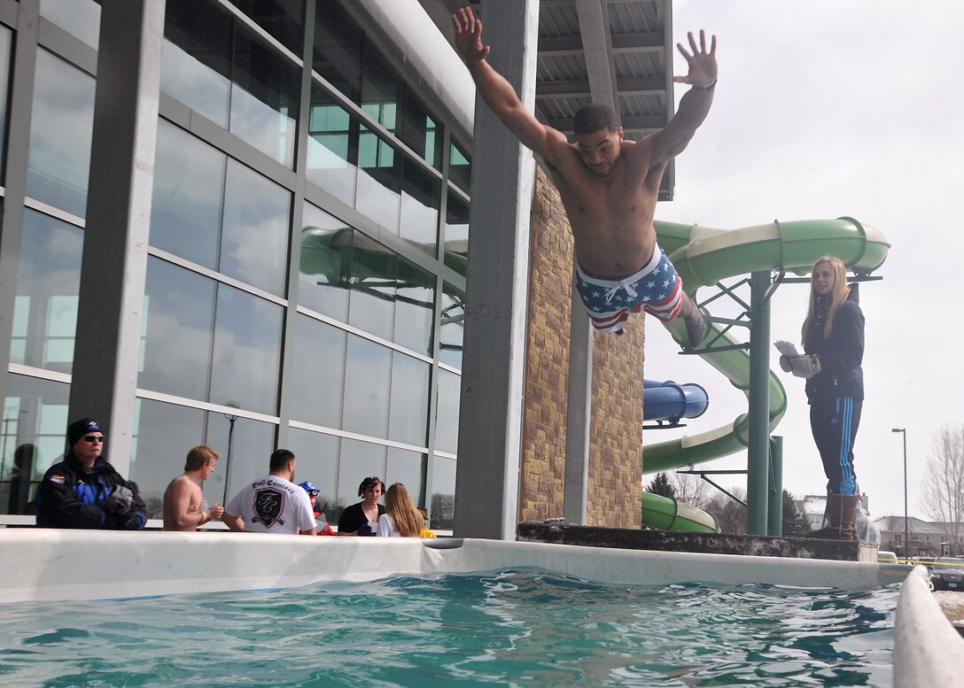 Senior Airman Christopher Horton, 319th Civil Engineer Squadron electrician journeyman, leaps into a pool for the sixth annual Polar Plunge on March, 22, 2014, at the Choice and Health Fitness Center in Grand Forks, N.D. Horton and Senior Airman Dawid Mludzik, 319th CES, raised more than $3,000 for the North Dakota Special Olympics. (U.S. Air Force photo/Senior Airman Xavier Navarro) 