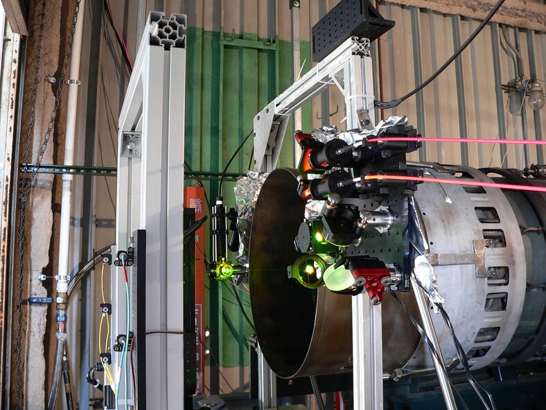 Two hollow-core fibers (pink-colored at right) provide remote CARS measurements at the exhaust plane of the J85 engine at the University of Tennessee Space Institute. (Photo provided)