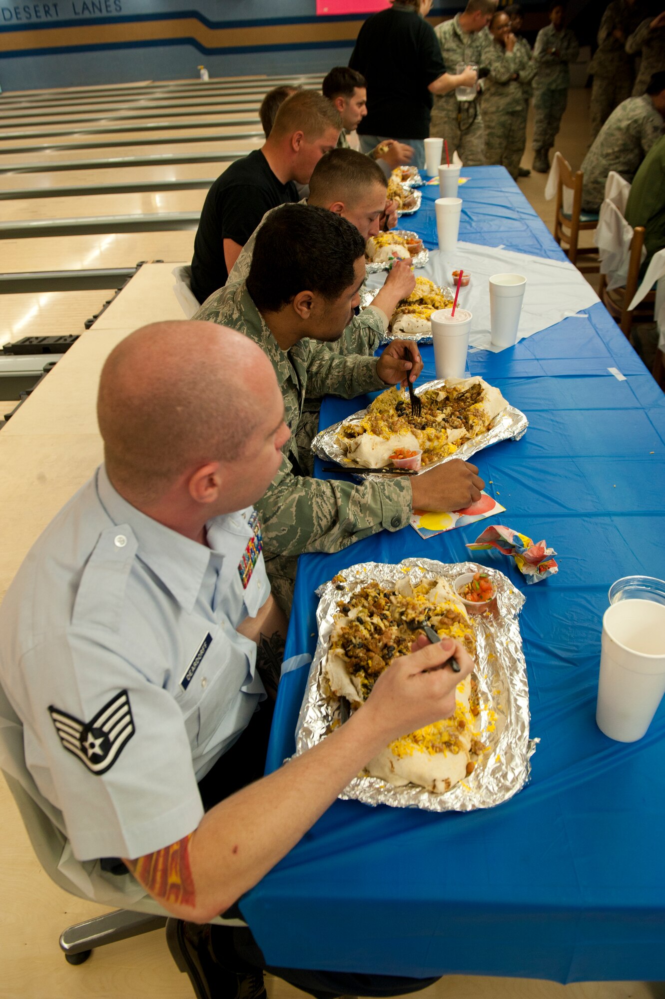 Members of Team Holloman take part in the Airman vs. Food eating competition at Holloman Air Force Base, N.M., March 13. Ace’s Ten Pin Cantina at the HAFB bowling alley hosted an eating competition in which participants had 20 minutes to eat five-pound burritos. (U.S. Air Force photo by Airman 1st Class Aaron Montoya / Released)