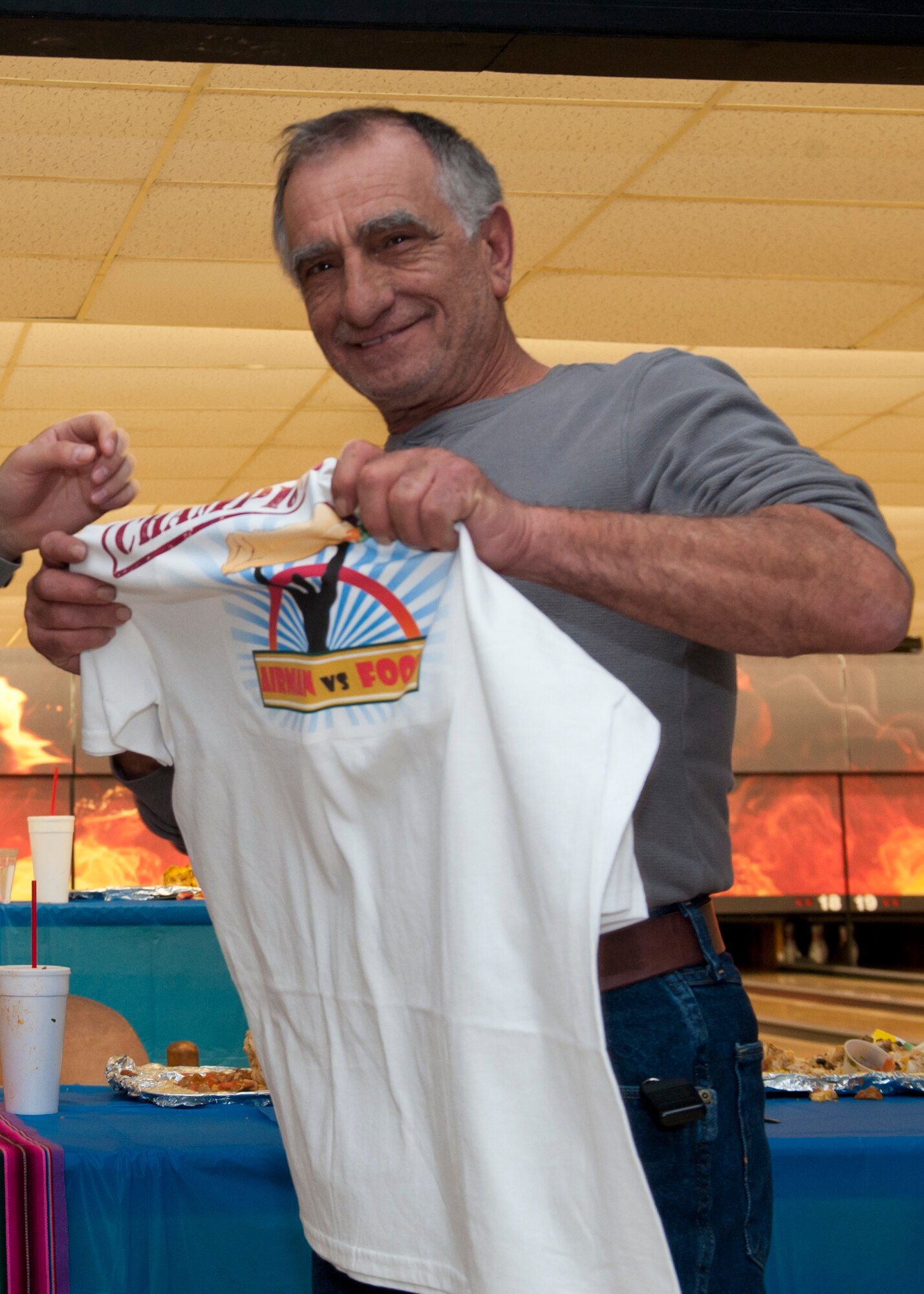 Antonio Biancaniello, 49th Materiel Maintenance Support Squadron material handler and forklift operator, celebrates tying for first place in the Airman vs. Food eating competition at Holloman Air Force Base, N.M., March 13. Ace’s Ten Pin Cantina at the HAFB bowling alley hosted an eating competition in which participants had 20 minutes to eat five-pound burritos. (U.S. Air Force photo by Airman 1st Class Aaron Montoya / Released)