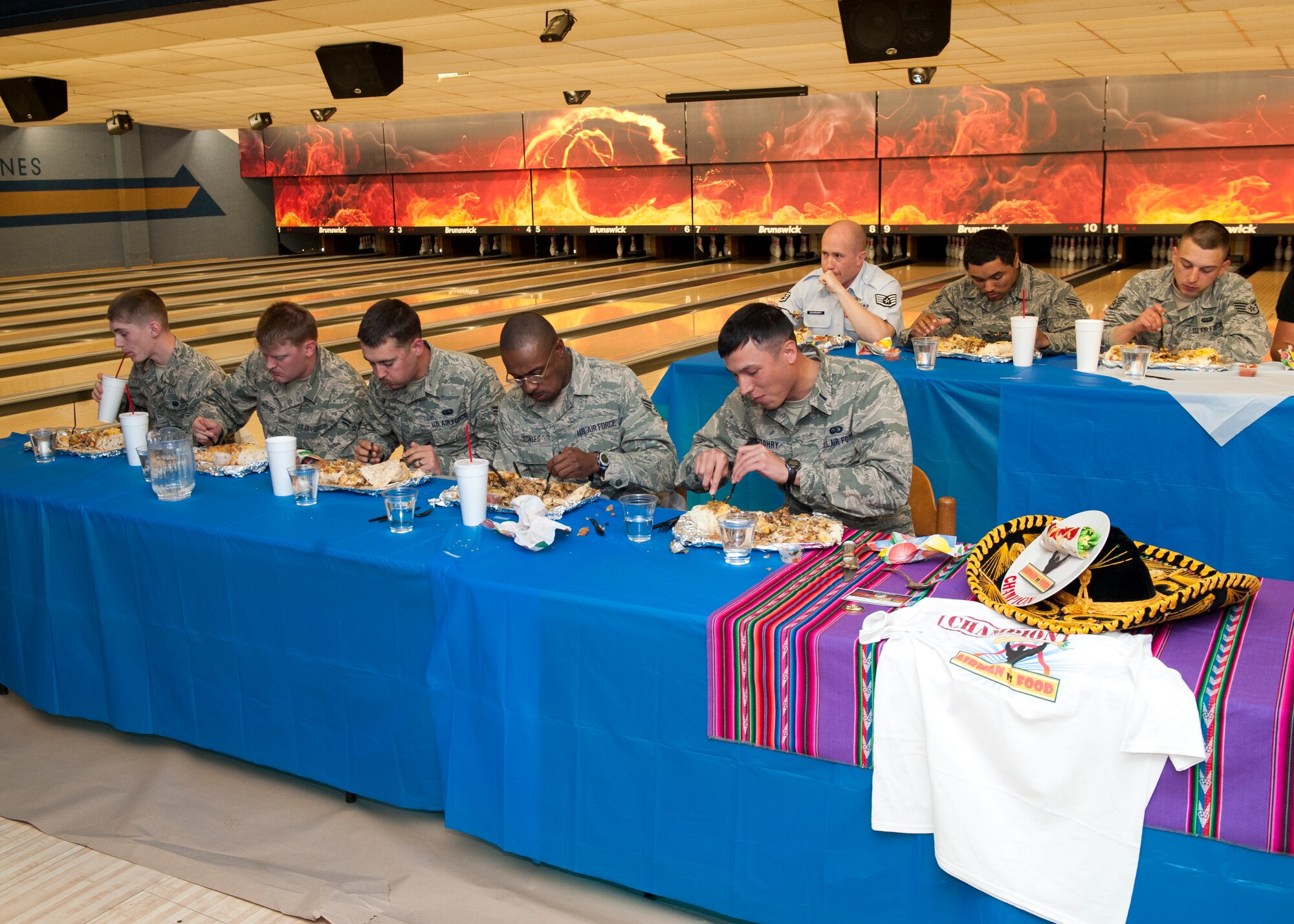 Members of Team Holloman take part in the Airman vs. Food eating competition at Holloman Air Force Base, N.M., March 13. Ace’s Ten Pin Cantina at the HAFB bowling alley hosted an eating competition in which participants had 20 minutes to eat five-pound burritos. (U.S. Air Force photo by Airman 1st Class Aaron Montoya / Released)