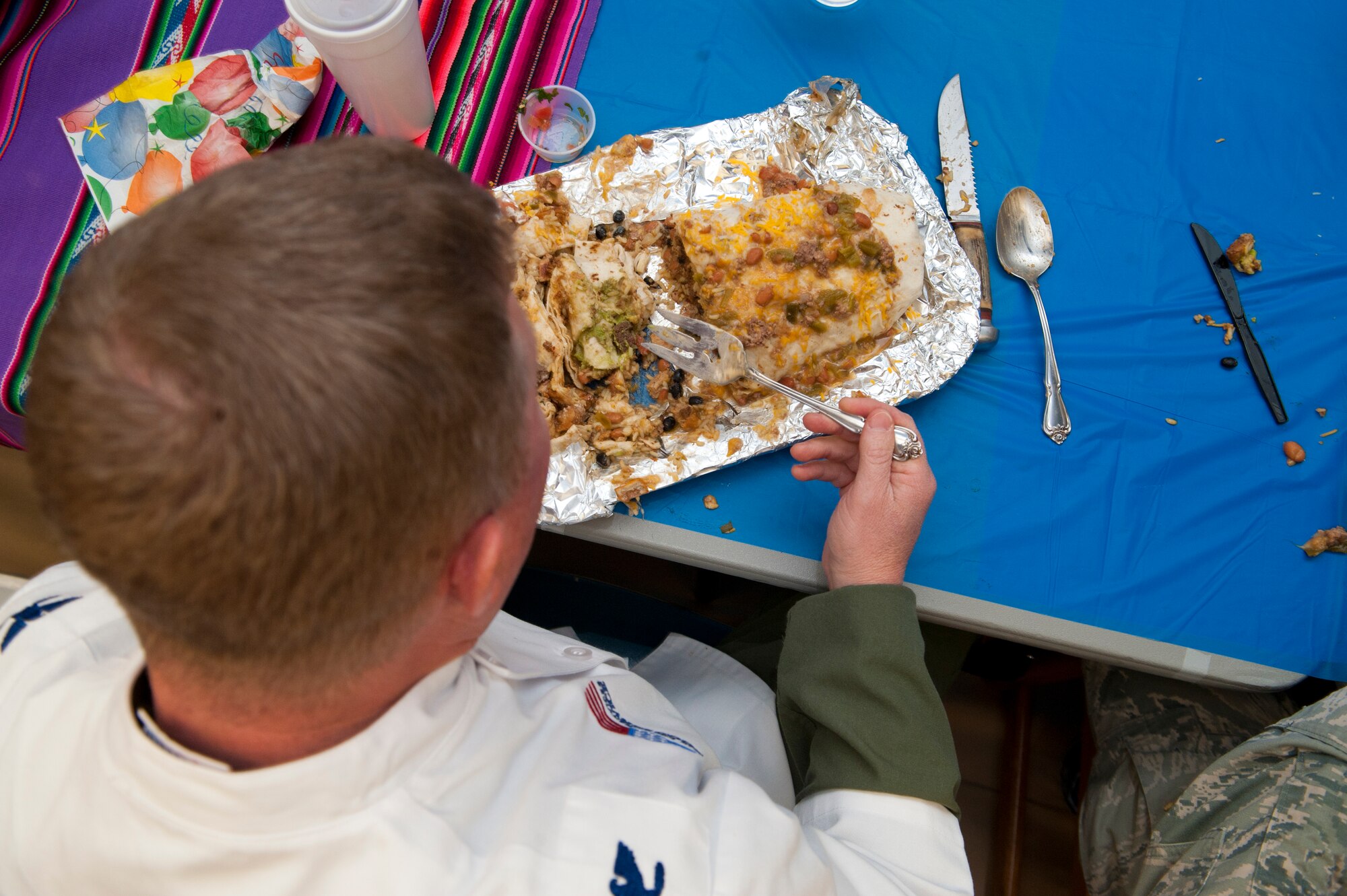 Colonel Andrew Croft, 49th Wing commander, joins members of Team Holloman in the Airman vs. Food eating competition at Holloman Air Force Base, N.M., March 13. Ace’s Ten Pin Cantina at the HAFB bowling alley hosted an eating competition in which participants had 20 minutes to eat five-pound burritos. (U.S. Air Force photo by Airman 1st Class Aaron Montoya / Released)