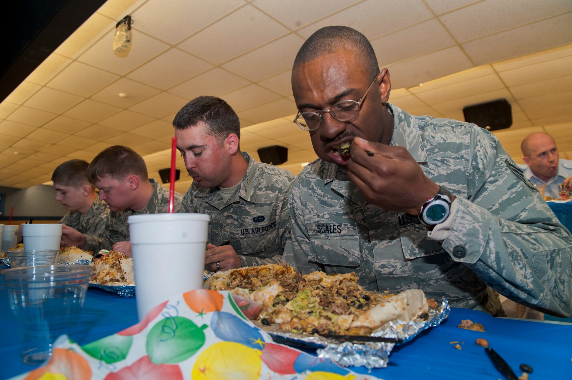 Members of Team Holloman take part in the Airman vs. Food eating competition at Holloman Air Force Base, N.M., March 13. Ace’s Ten Pin Cantina at the HAFB bowling alley hosted an eating competition in which participants had 20 minutes to eat five-pound burritos. (U.S. Air Force photo by Airman 1st Class Aaron Montoya / Released)