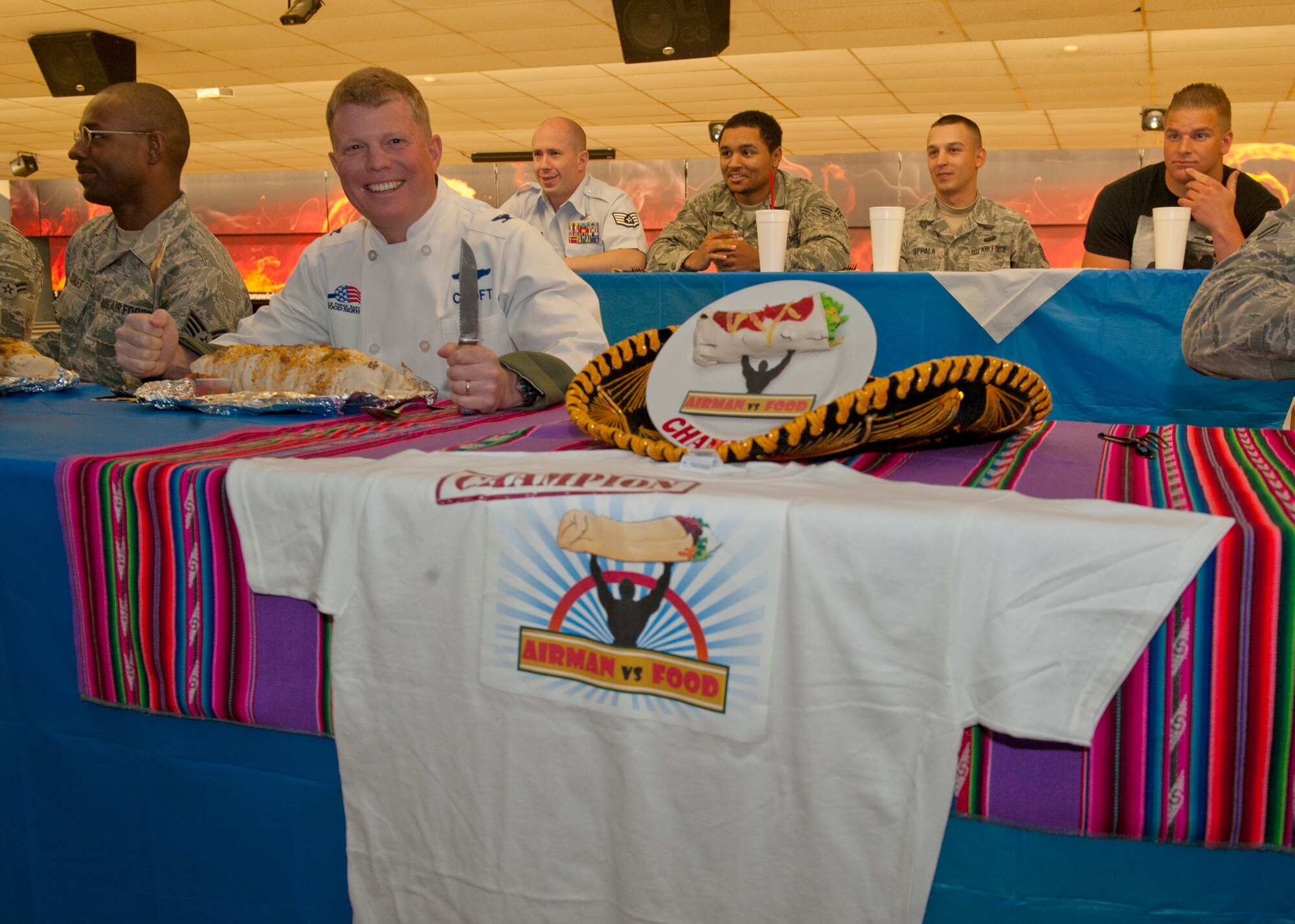 Colonel Andrew Croft, 49th Wing commander, prepares to join members of Team Holloman in the Airman vs. Food eating competition at Holloman Air Force Base, N.M., March 13. Ace’s Ten Pin Cantina at the HAFB bowling alley hosted an eating competition in which participants had 20 minutes to eat five-pound burritos. (U.S. Air Force photo by Airman 1st Class Aaron Montoya / Released)