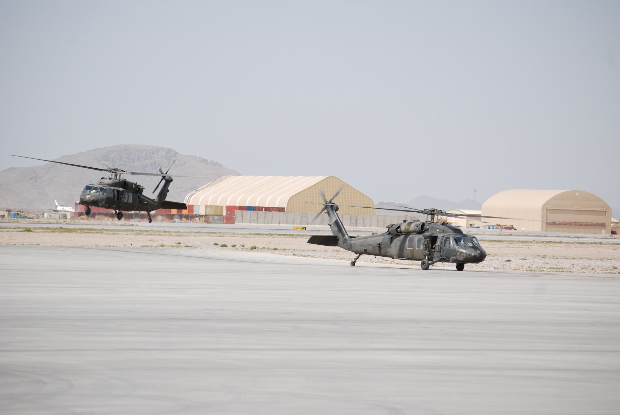 Two Army UH-60 Black Hawk helicopters arrive at Kandahar Airfield, March 20, 2014. The UH-60 is frequently used for troop movements within an area of operations. (U.S. Air Force photo by Capt. Brian Wagner/Released)