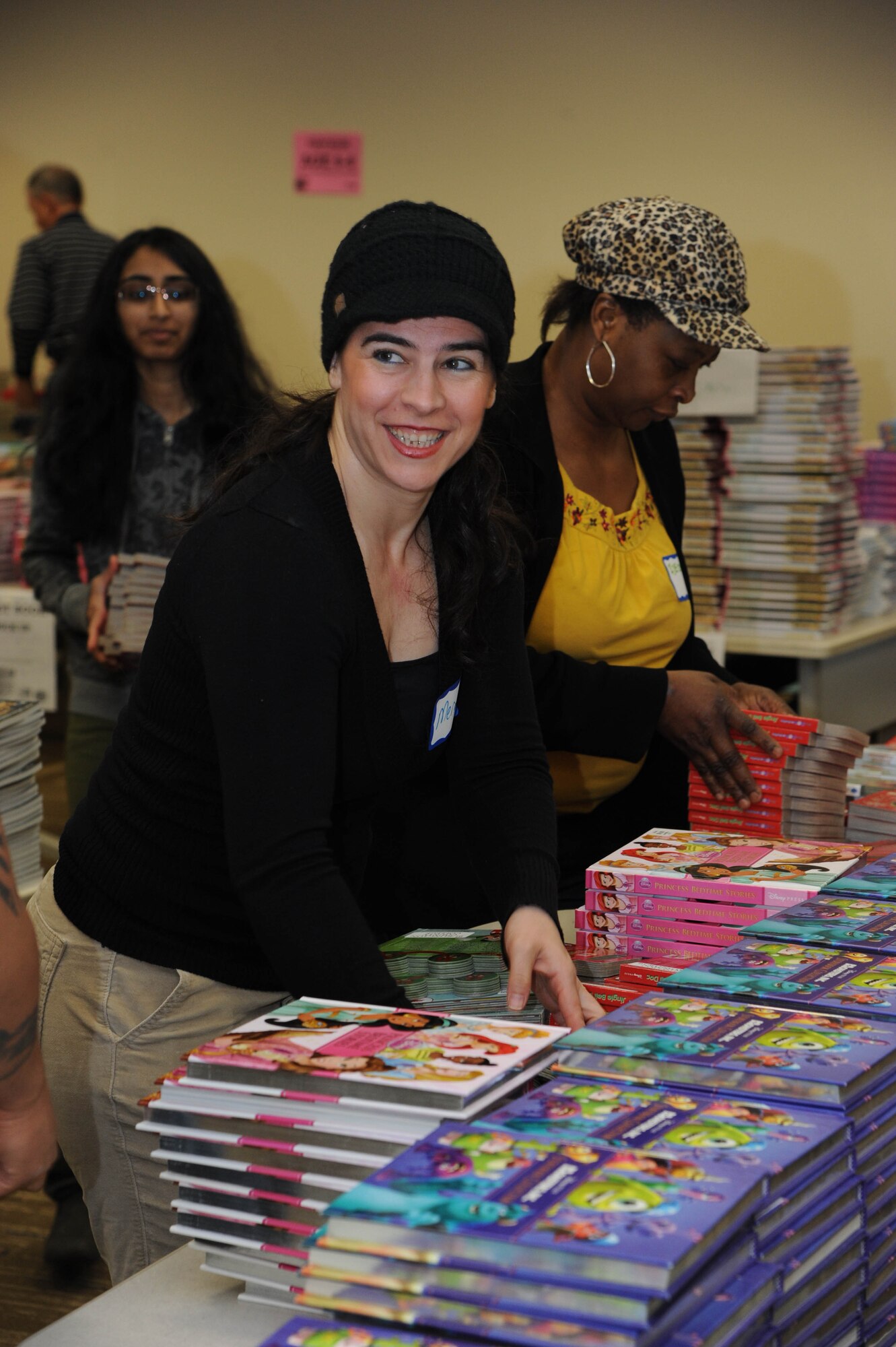 Meral Muyesser, Burlington County College English Second Language Program coordinator, arranges children’s books donated by First book in coordination with BCC to Joint Base McGuire-Dix-Lakehurst March 19, 2014, at the BCC campus in Mount Laurel, N.J. Muyesser is one of approximately 100 volunteers that contributed to the week-long event. (U.S. Air Force photo by Airman 1st Class Sean M. Crowe/Released)