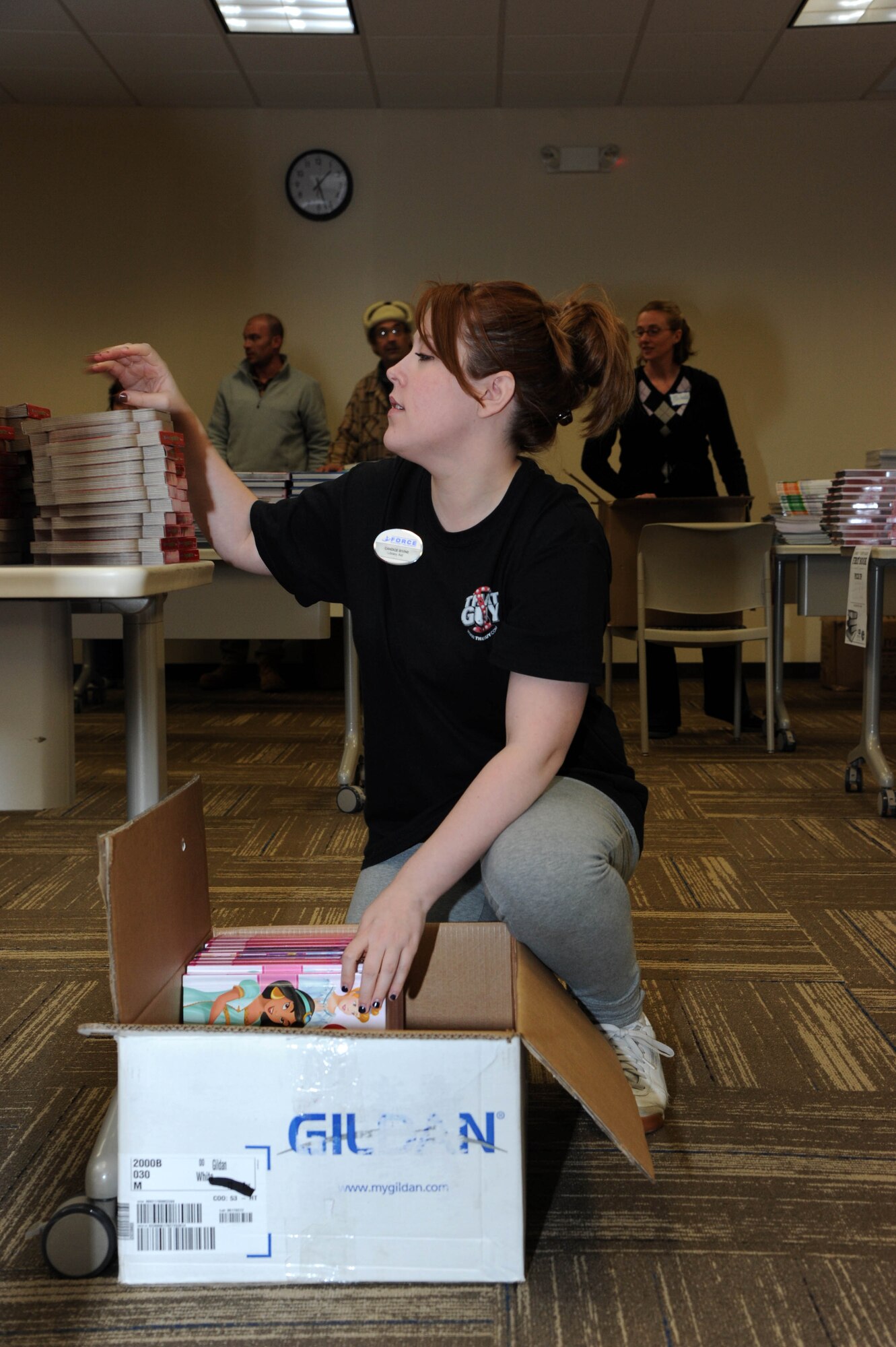 Candice Bivins, 87th Force Support Squadron Librar-E and Resource Commons Center children’s service director, packs books donated by First Book in coordination with Burlington Community College faculty and students March 19, 2014, at the Burlington Community College campus in Mount Laurel, N.J. The books were donated to Joint Base McGuire-Dix-Lakehurst through a BCC initiative to promote child literacy in the local community. (U.S. Air Force photo by Airman 1st Class Sean M. Crowe/Released)