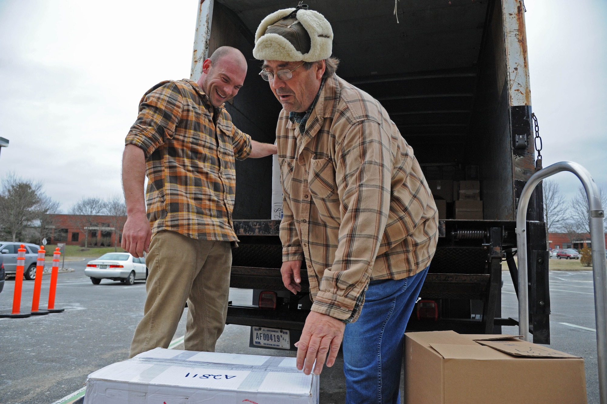 David Kolarsick (left), 87th Force Support Squadron motor vehicle operator, and Alfred E. Bowers, 87th FSS motor vehicle helper, load boxes of books donated by First Book in coordination with Burlington Community College faculty and students March 19, 2014, at the BCC campus in Mount Laurel, N.J. The program distributed books to Joint Base McGuire-Dix-Lakehurst to promote child literacy and foster community relations between organizations. (U.S. Air Force photo by Airman 1st Class Sean M. Crowe/Released) 