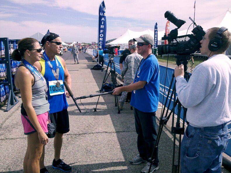 Ken LaRock (center right holding microphone) and Matthew Clouse (operating camera) interview runners who competed in the Air Force Marathon, an annual event held in September at Wright-Patterson Air Force Base. LaRock and Clouse are videographers who contributed to the Agile Combat Support Directorate’s “Every Airman, Every Aircraft, Every Day” video production. The production was named “Outstanding Field Production” at the 2013 Air Force Media Contest. (Air Force photo by Brian Duke)