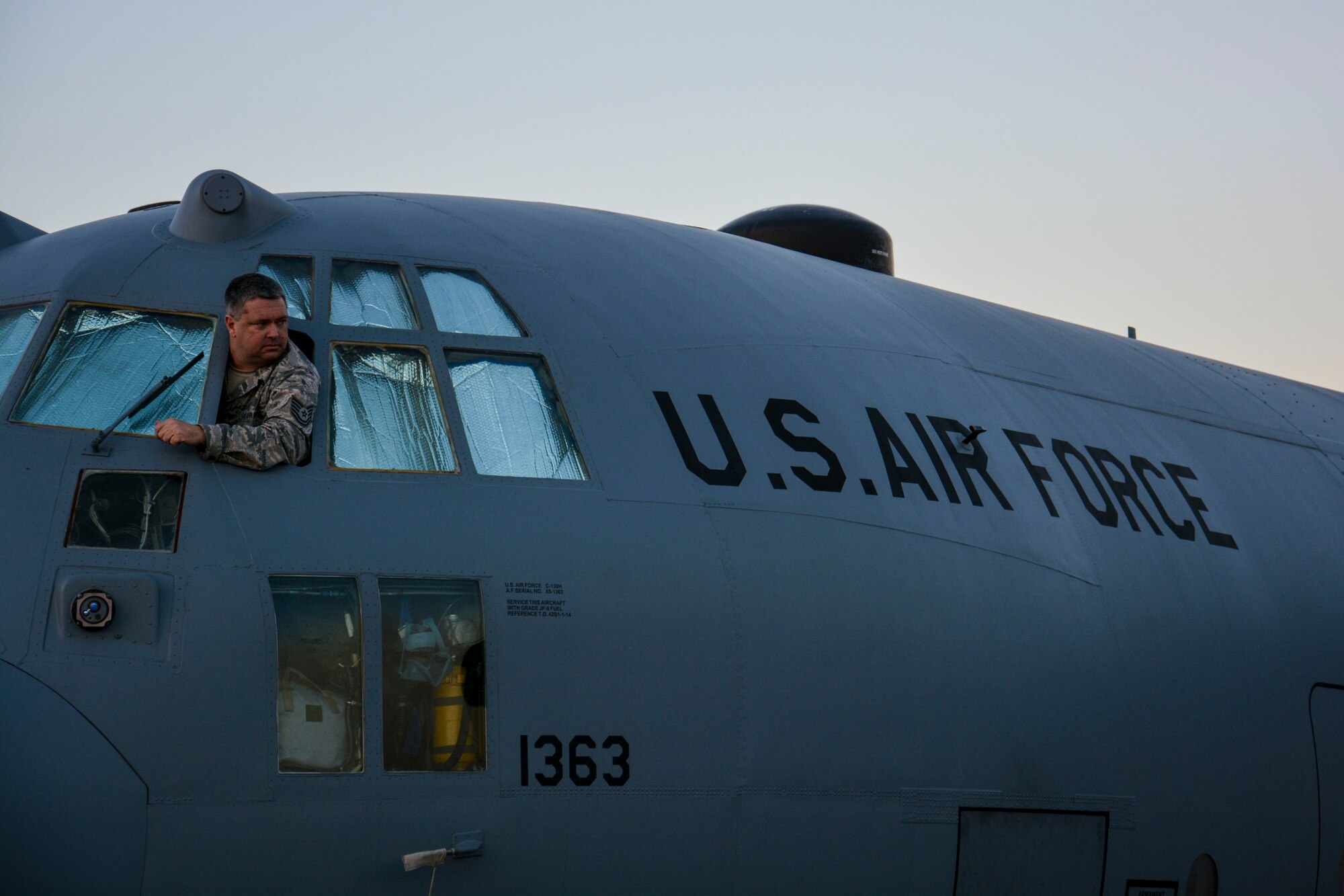 An airman assigned with the Texas Air National Guard, surveys the area before other airmen begin to tow a C-130 Hercules at the FIDAE airshow in Santiago, Chile, March 24.  Nearly 60 U.S. airmen are participating in subject matter expert exchanges with Chilean air force counterparts during the week of FIDAE, and as part of the events will host static displays of the C-130 Hercules and F-16 Fighting Falcon during the FIDAE Air Show in Santiago, March 25-30. The exchanges, conducted regularly throughout the year, involve U.S. airmen sharing best practices and procedures to build partnerships and promote interoperability with partner-nations throughout South America, Central America and the Caribbean. (U.S. Air Force photo by Capt. Justin Brockhoff/Released)